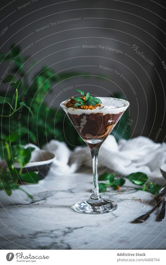 Tasty chocolate and coconut mousse dessert sweet treat glass delicious mint garnish leaf yummy gourmet fresh tasty portion food serve table green plant