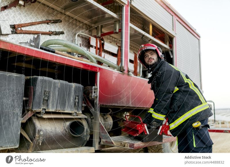 Fire truck and firefighter on field equipment emergency countryside natural service protect help smog save occupation professional uniform safety fireman rescue