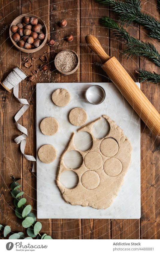 Dough and cookie mold on wooden table cutter polvoron christmas form hazelnut pastry dough raw ingredient food fresh tradition sweet shape shortbread new year