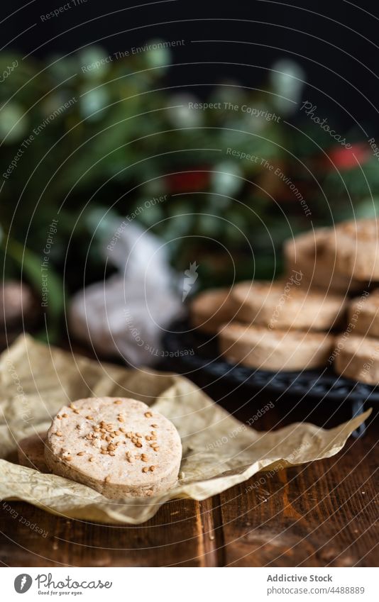Delicious nut shortbread cookies on plate on table polvoron pile hazelnut christmas wrap paper dessert sweet dark food delicious celebrate festive holiday