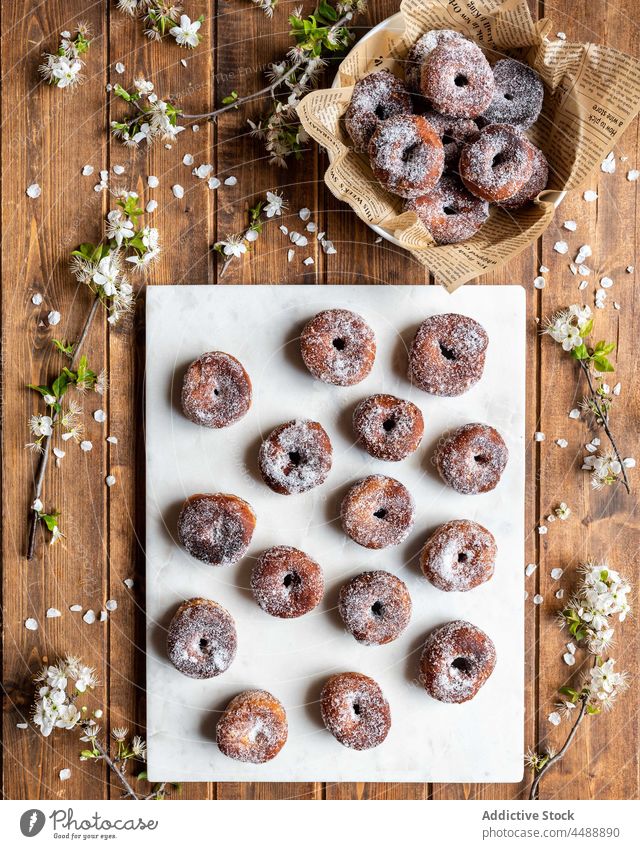 Delicious fritters on wooden table donut lent sweet dessert layout tasty flower pastry appetizing delicious fresh food yummy nutrition doughnut bakery blossom