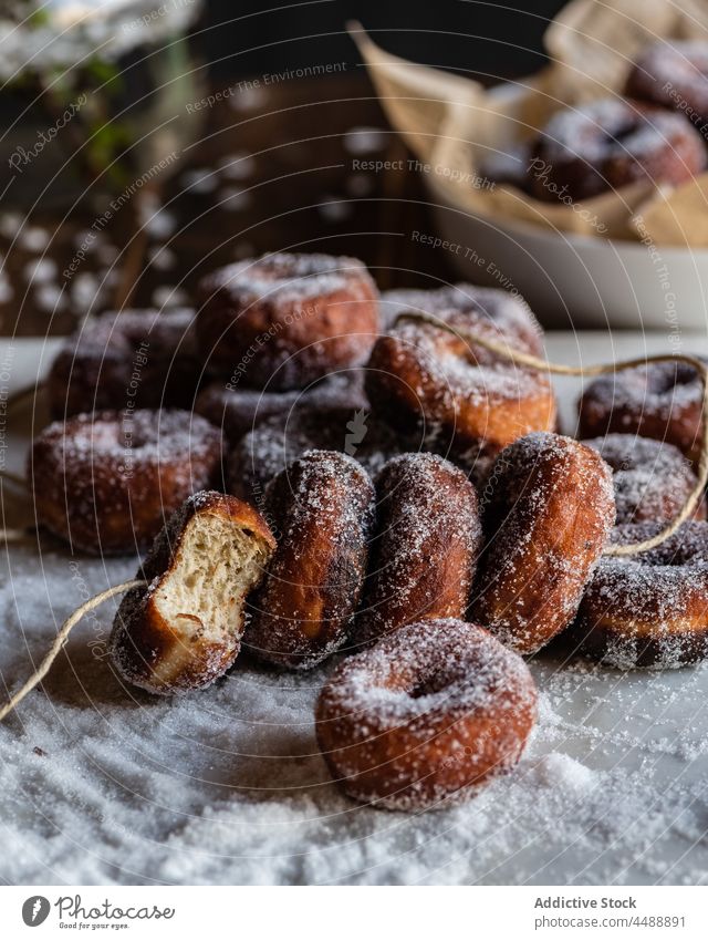 Fritters in sugar powder on table fritter donut sweet pastry dessert doughnut treat delicious yummy tasty food appetizing baked calorie bakery serve nutrition