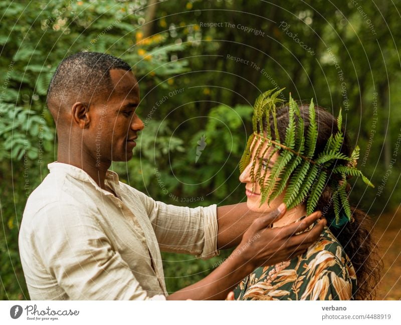 portrait of a diverse ethnics loving couple in a forest interracial love caucasian woman happy relationship together people young lifestyle romance girlfriend