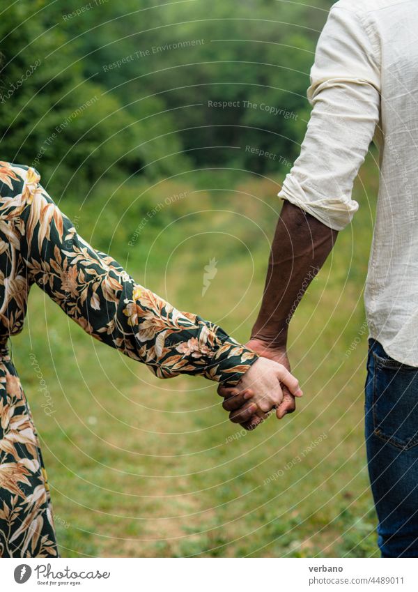 interracial couple holding hands diversity concept afro caucasian diverse love family new order culture ethnics woman people smiling outdoors smile happiness