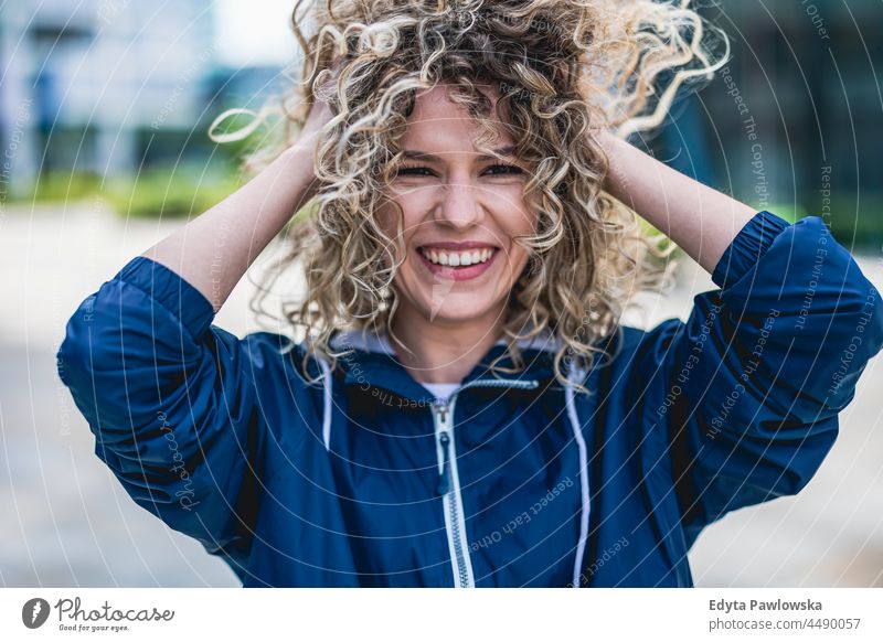 Portrait of laughing young woman outdoors Warsaw day fun curls hairstyle summer happiness tourist beauty smiling cheerful real people city life blond hair 20s