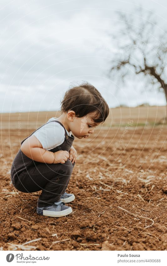 Child watching ants on the field childhood 1 - 3 years Caucasian one person side view Curiosity Explore Happiness Life Day Authentic Colour photo Joy Cute