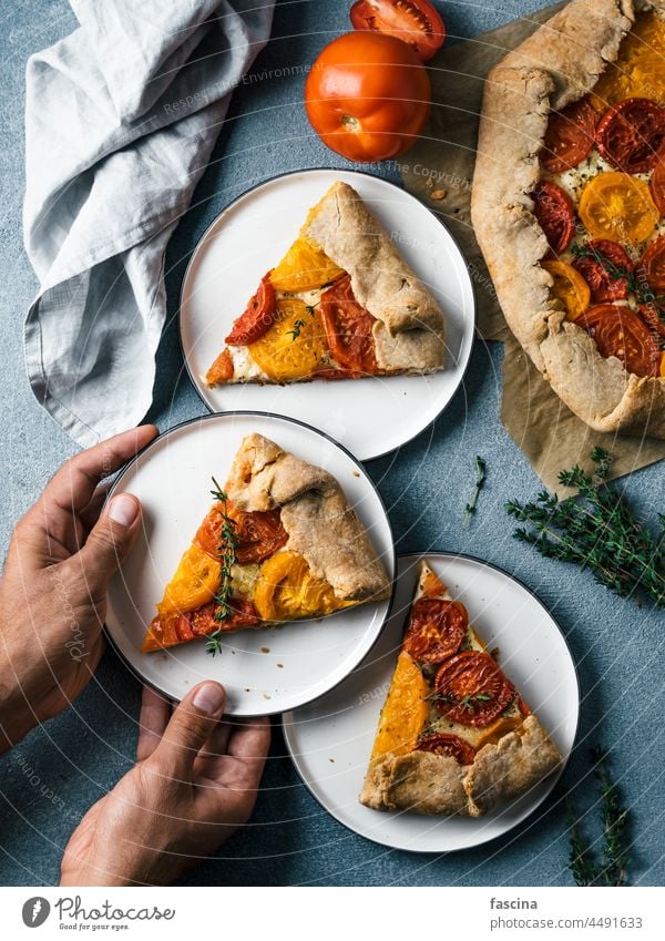 tomatoes and cheese tart or galette ready-to-eat pie cake tarte ideas recipes hand piece healthy breakfast lunch snack whole rye wheat mozzarella harvest