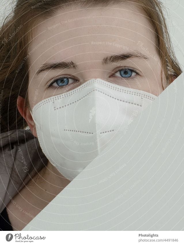 Intense look of a young woman with FFP2 mask viruses Mouth protection mask Contagious portrait Respirator mask Infection Face mask State of health Safety