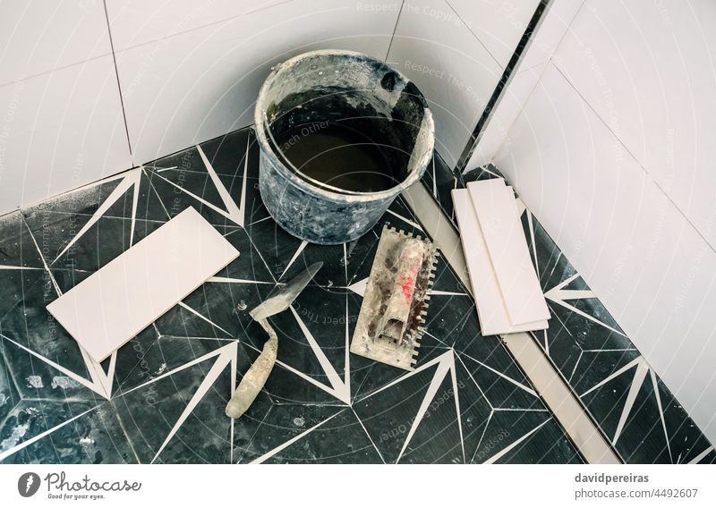 Set of tools and masonry equipment still life construction tile bathroom set reform nobody trowel spatula bucket pieces tiled wall hydraulic style tile dirty
