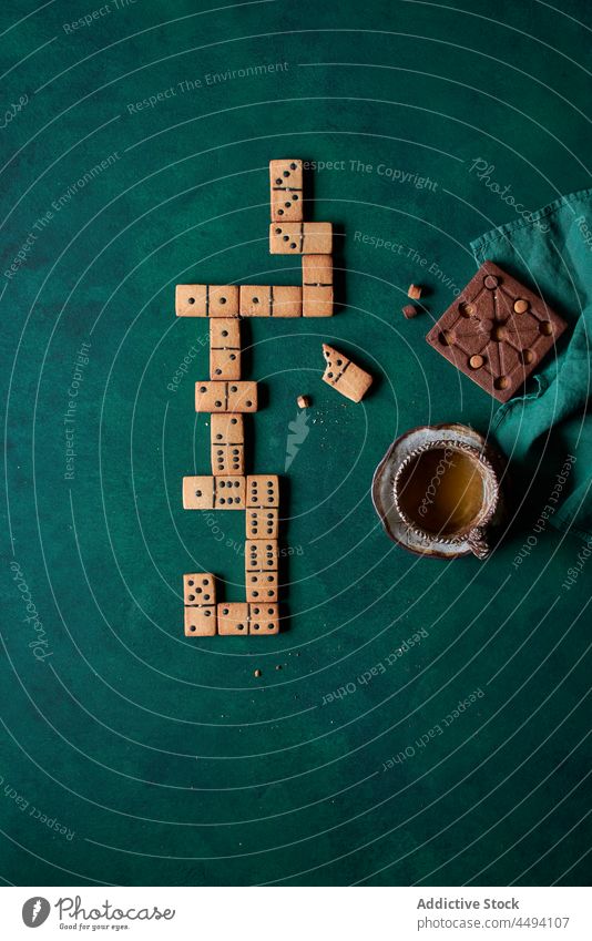Domino cookies near hot coffee domino edible dessert sweet pastry drink biscuit treat baked delicious tasty beverage confectionery cup mug food yummy shape game