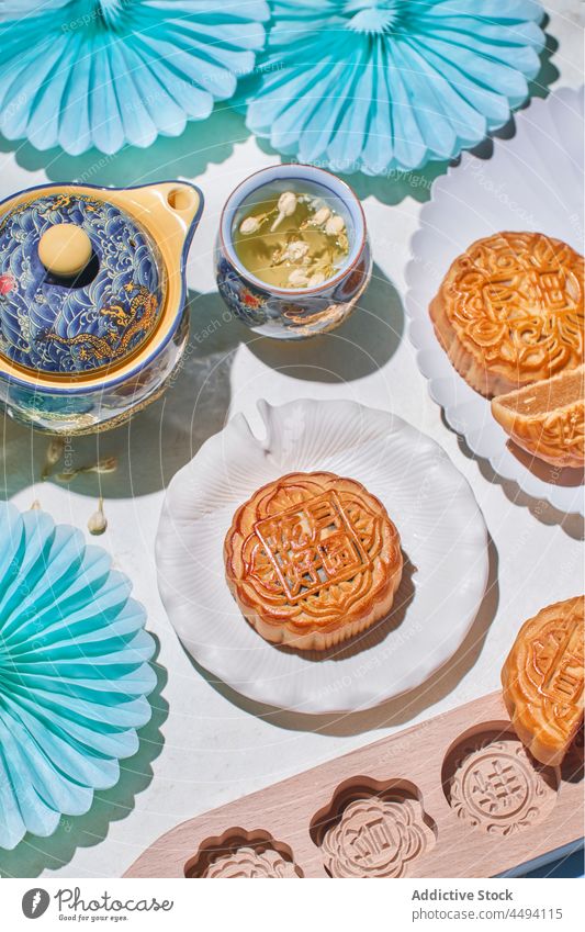 Sweet Chinese mooncakes near tea bakery pastry dessert chinese traditional sweet hot drink teapot food beverage treat cuisine culture tasty cut filling table