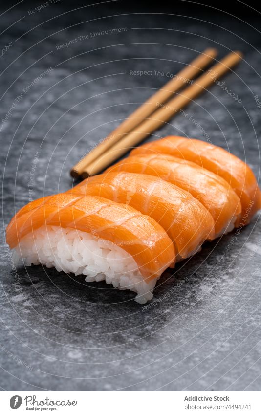 Delicious sushi with fresh salmon japanese tradition cuisine wooden chopsticks rice seafood meal fish serve set asian food tasty table delicious marble