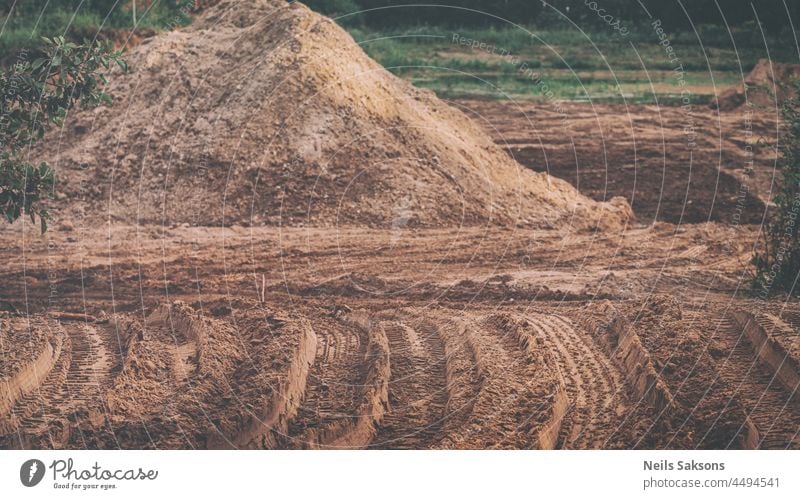 sand and gravel quarry, tractor and heavy truck tire prints, dirt road, heap of industrial sand Car Heap Imprint Many Material Raw Sandy anorganic background