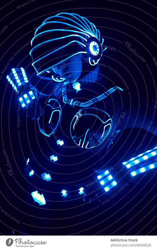 Anonymous person in modern LED costume suit space illuminate futuristic neon fantasy led high tech cyborg character style glow light dynamic concept design