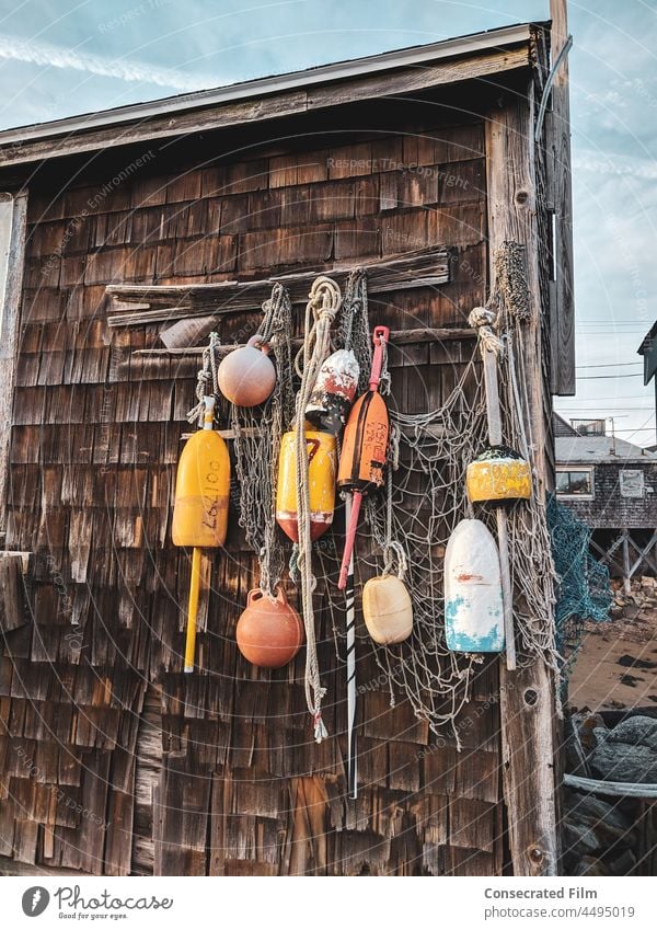 https://www.photocase.com/photos/4495019-old-fishing-shack-with-lobster-buoys-ropes-and-nets-on-the-coast-photocase-stock-photo-large.jpeg