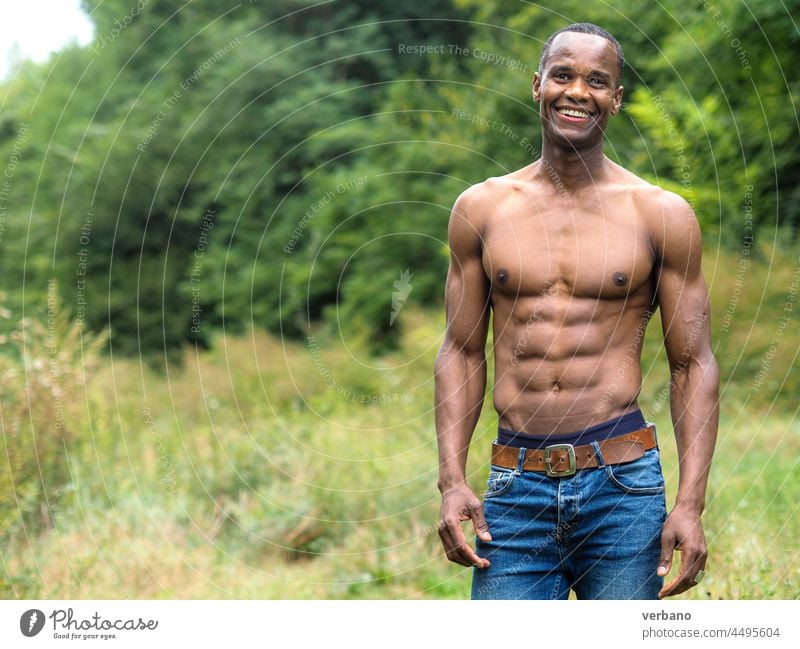 portrait of a muscled fit happy young black man outdoors male muscular athlete strength fitness background bodybuilder strong handsome bodybuilding lifestyle