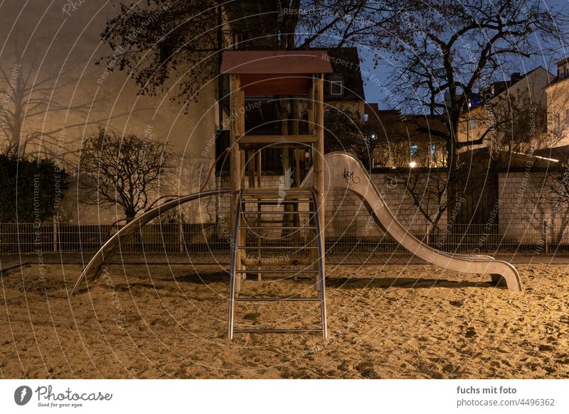Playground at night Night shot game device Lighting Town Dark Colour photo Reflection Deserted Exterior shot Slide climbing scaffold Sand Wall (barrier) roofs
