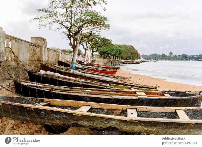 Old boats on sandy shore near ocean on tropical island beach coast palm nature aged wooden São Tomé and Príncipe africa old green vessel empty plant tree