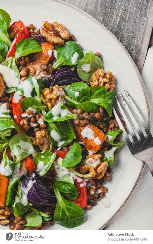Delicious salad with vegetables and basil leaves meal food walnut lentil cuisine serve healthy food dish delicious organic portion green plate tasty nutrition