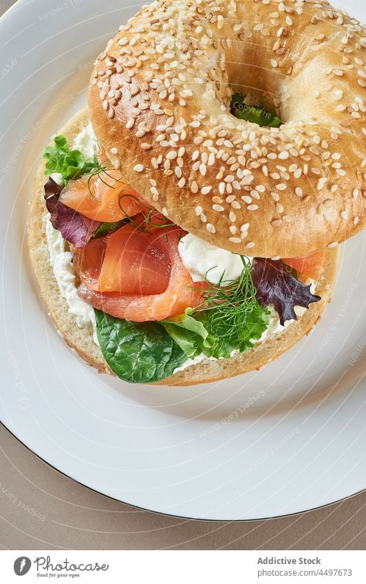 Split bagel with filling of herbs and vegetables food tasty half appetizing split snack delicious organic nutrition ingredient yummy fresh culinary baked