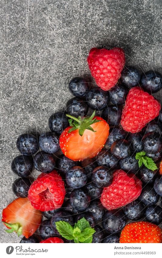 Fresh summer berries such as blueberries, strawberries, raspberries berry strawberry raspberry blueberry top fresh macro healthy sweet black organic diet view