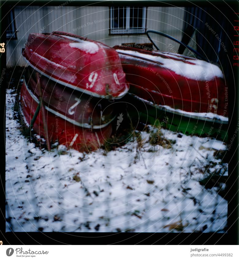 Rowing boats in hibernation Rowboats Stack Watercraft Boathouse Fence Winter dormant Snow Cold Colour photo Analogue photo Ice figures number 1 2 6 9 Frost