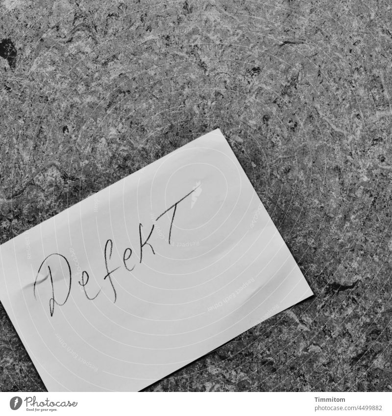 DefekT - Note Clue Signage Piece of paper Labeled Characters Handwritten Ground Lie Letters (alphabet) Black & white photo Interior shot broken floor