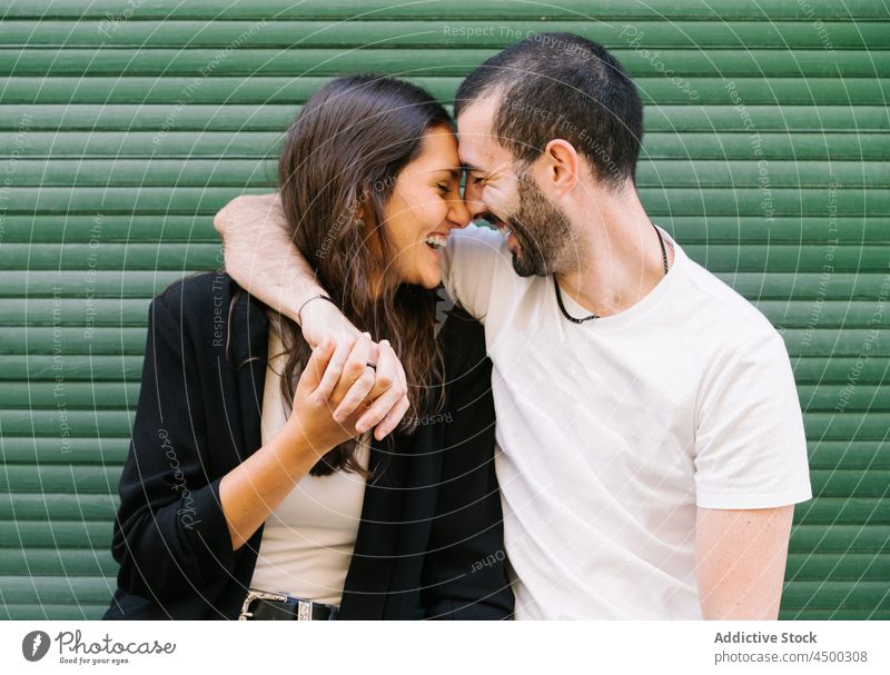 Joyful loving ethnic couple smiling and touching foreheads on street touch forehead laugh hug love cheerful relationship together romantic happy affection