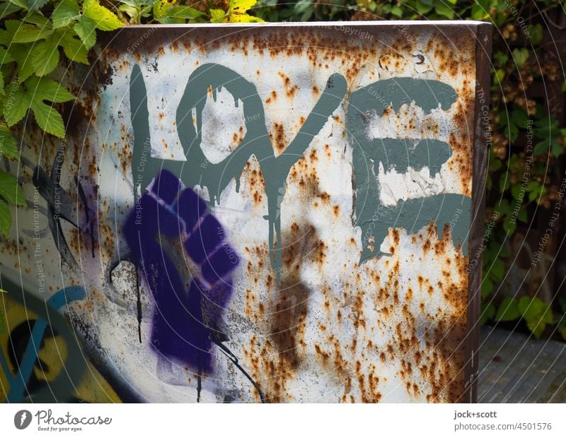 Solidarity and strength meets love Street art lifted Symbols and metaphors Aggression Word English wall park Prenzlauer Berg Berlin social movement Sign Gesture