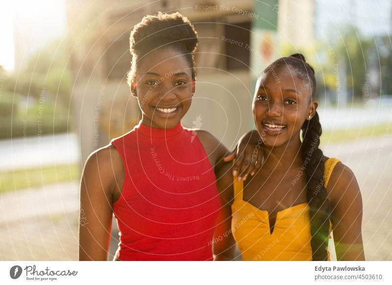 Portrait of two beautiful young women standing together outdoors youth sisterhood attractive girlfriends real people millennials cool diversity black friendship