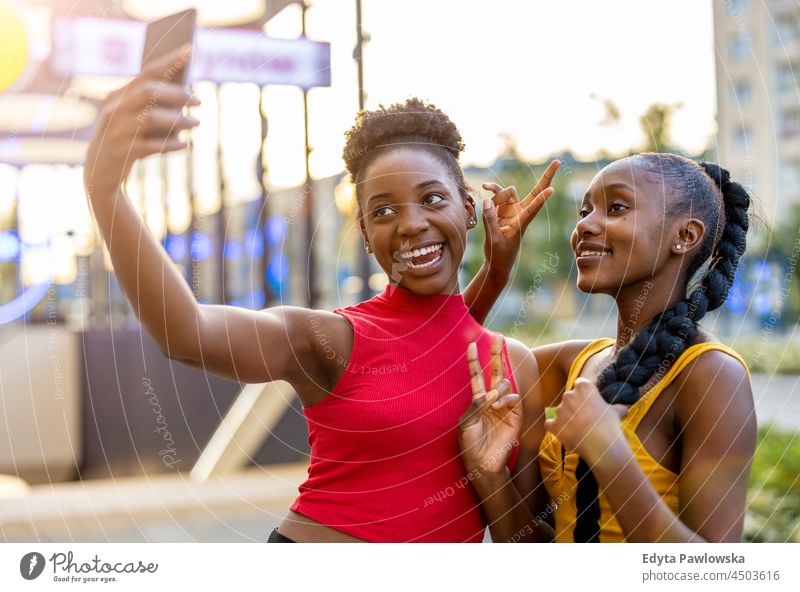 Happy girlfriends taking a selfie together outdoors youth sisterhood attractive real people millennials cool diversity black friendship girls summer beautiful