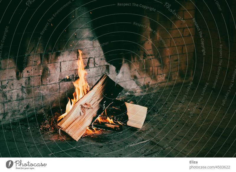 Burning logs in the fireplace. Fire. Fireside Fireplace blaze Logs Cozy Heat Hot Warmth Flame Wood