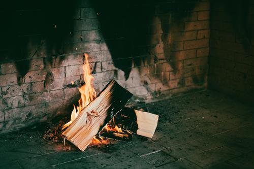 Burning logs in the fireplace. Fire. Fireside Fireplace blaze Logs Cozy Heat Hot Warmth Flame Wood