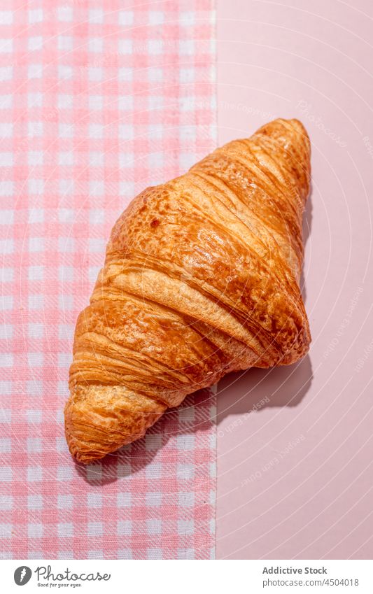 Fresh baked croissant placed on pink table delicious yummy tasty dessert tablecloth sweet food fresh bakery product calorie daylight nutrition breakfast