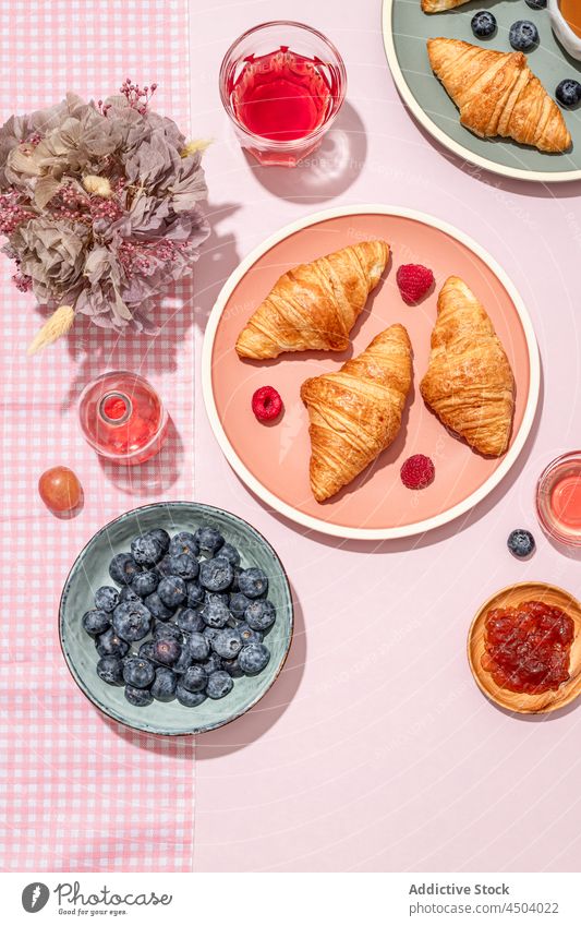 Plates with tasty croissants served with jam and berries placed on table dessert sweet breakfast food pastry delicious morning fresh yummy berry composition