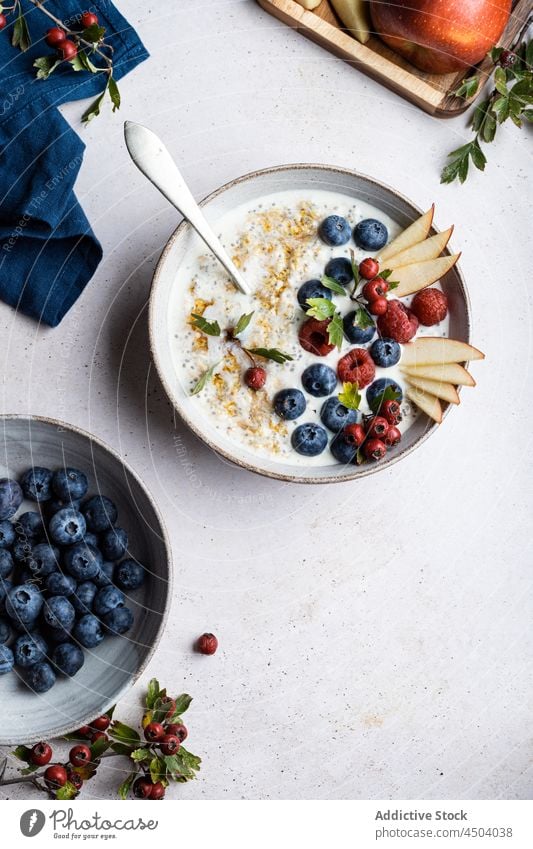 Porridge with berries on table porridge berry topping breakfast healthy food morning serve vitamin oatmeal blueberry raspberry fresh pear bowl organic portion
