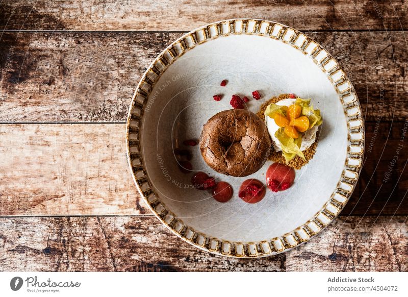 Bowl with delicious cake and granola with yogurt and fruit sauce dessert muffin food breakfast morning physalis baked sweet homemade tasty table gourmet snack