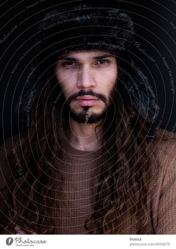 handsome man with long hair and winter hat guy male portrait winter clothing winter clothes Brazilian looking at camera long brown hair