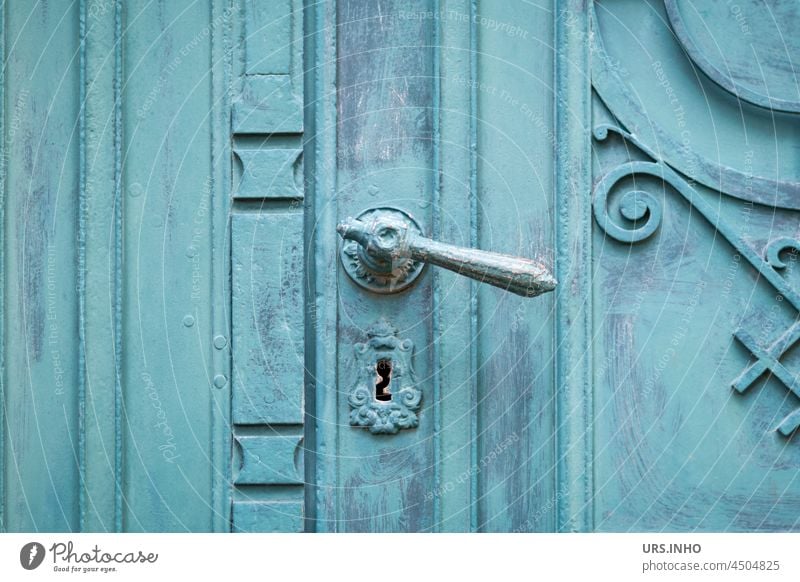 the old wooden door painted with turquoise paint is closed and only a look through the antique keyhole gives an idea of what is hidden behind it Goal Keyhole