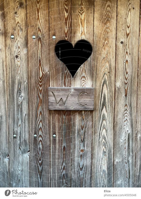 Wooden door of a toilet with heart. Plum toilet. plumsklo LAVATORY Toilet Old Heart john sign authored Peephole