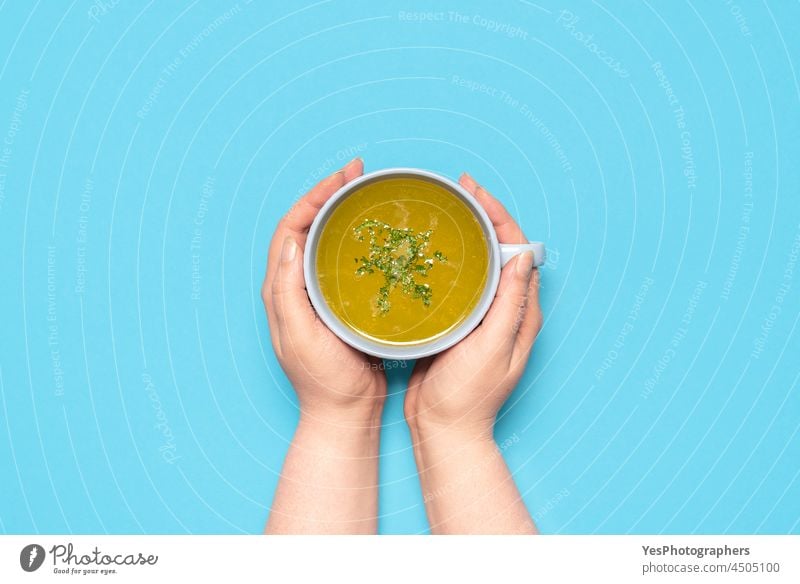 Chicken soup in a mug on a blue table, above view background beverage boiled bowl broth chicken chicken soup color comfort cooked copy space cuisine cut out