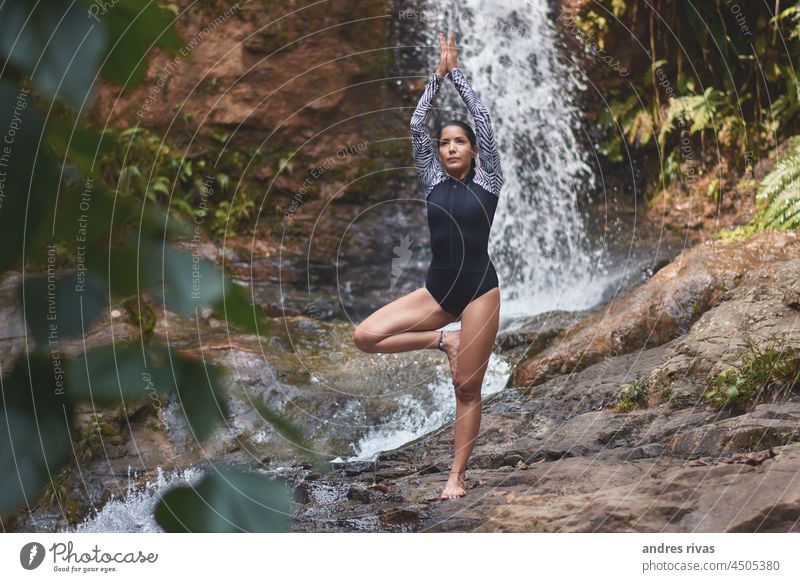 Woman doing yoga on a in the forest with a waterfall in the background woman rock river tree green nature Exterior shot day Landscape Sunlight Tropical