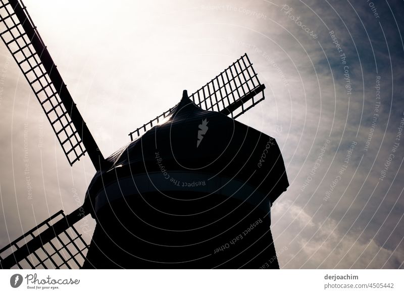 Quite old windmill, from the side, with its leaves. The sky is gray - blue. windmills Energy Renewable energy Environmental protection Ecological Eco-friendly