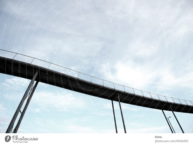 Lightness, curved Bridge Tall Elegant Curved Sky Clouds up pedestrian bridge stilts Bridge railing Bridge girder