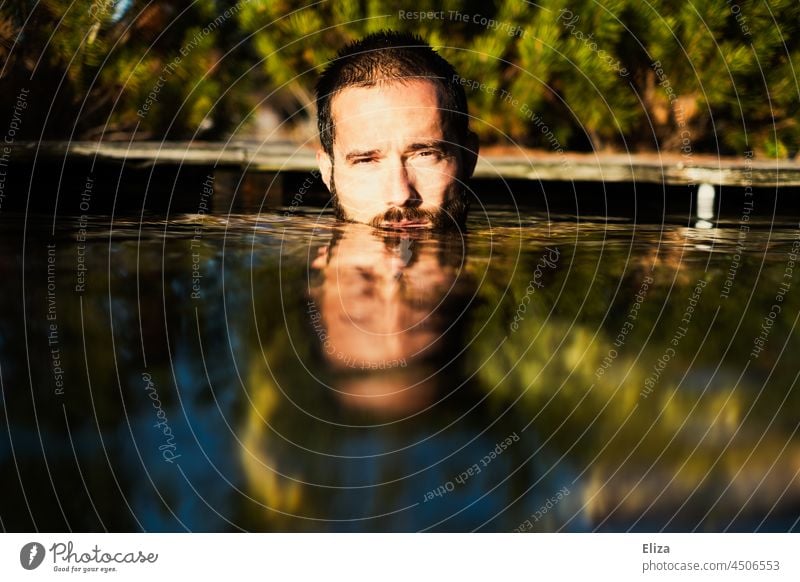 A man, face half under water, bathes outside, surrounded by nature, in the sunshine. Man Face Summer Lake Mirror surround Sun portrait Water Nature Human being