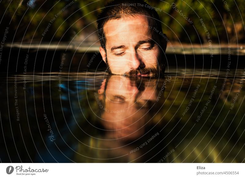 A man, face half under water, bathes outside, surrounded by nature, in the sunshine. Man Face Summer Lake Sun portrait Water Nature Human being Warmth Sunlight