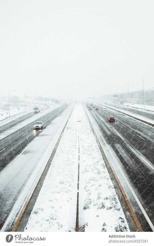 Car driving on asphalt road during snowfall car drive winter transport haze fog traffic gloomy motion cold roadway frost auto wintertime vehicle overcast spain