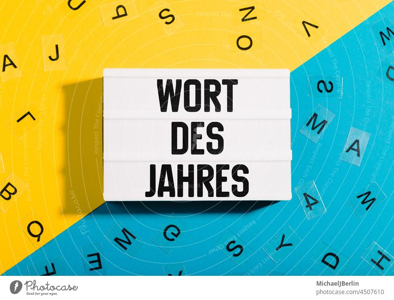 Language symbol image to word of the year with yellow blue paper background as title for german grammar and language Word Year Lightbox light box lightbox Text
