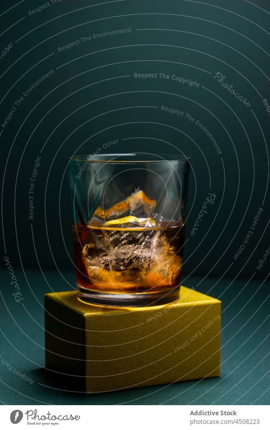 Glass with whiskey and ice glass cup cold drink alcohol dark cube crystal container beverage liquid cool booze lumber party luxury elegant liquor chill