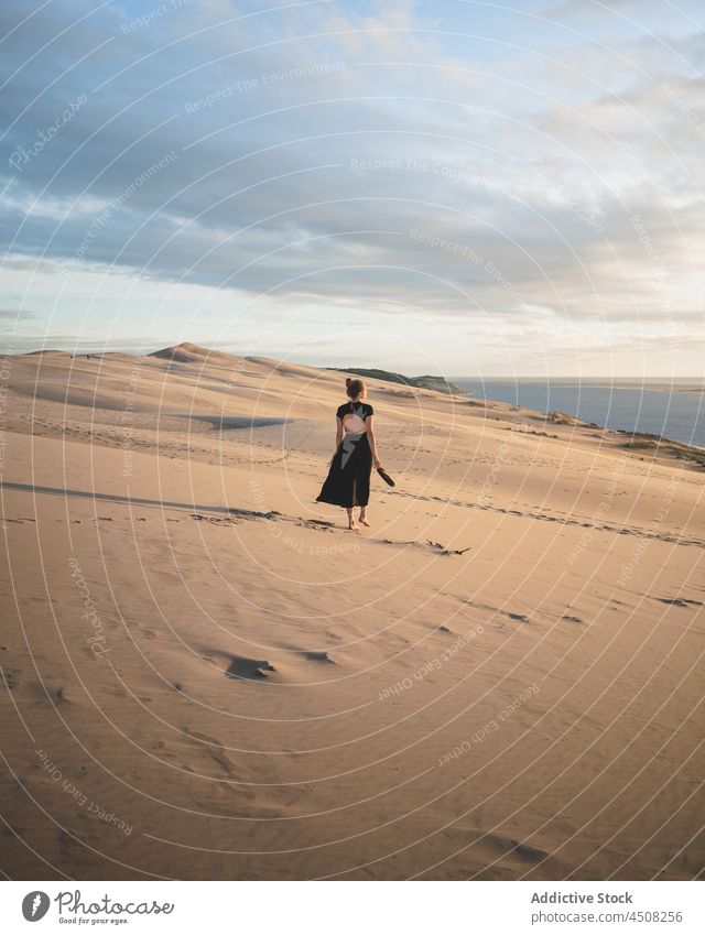 Woman in dress walking on sandy dunes woman desert arid hot harmony elegant exotic freedom female serene environment barefoot hill explore heat sunlight drought